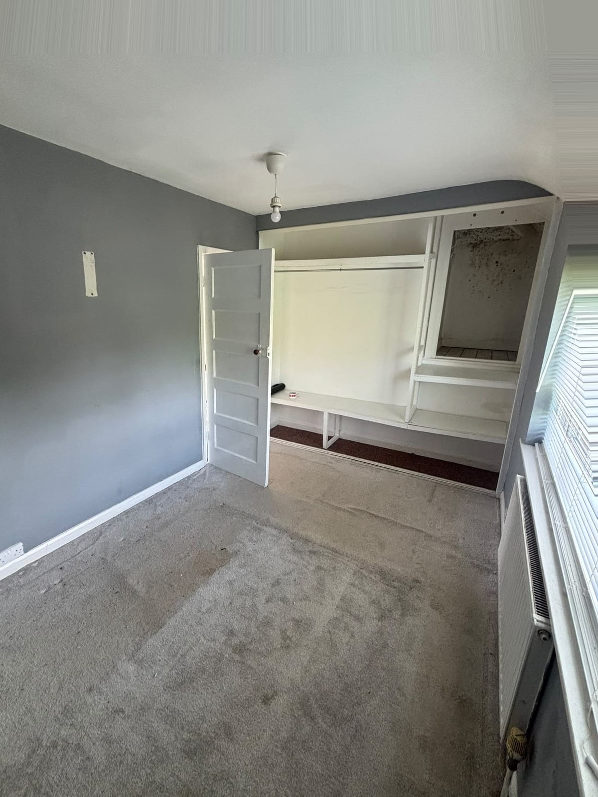 The same bedroom after the move, fully cleared